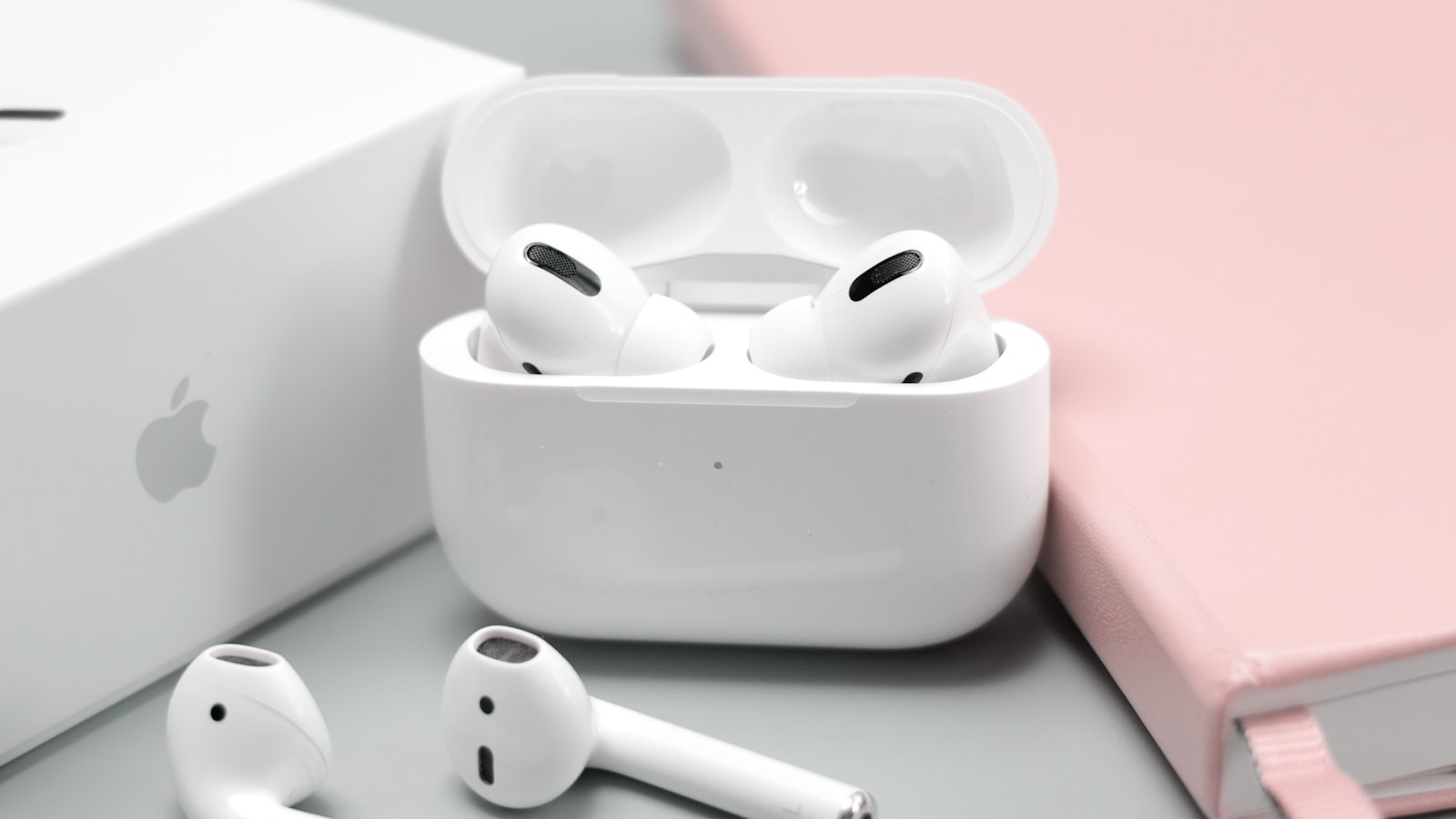 Wireless earbuds beside a phone